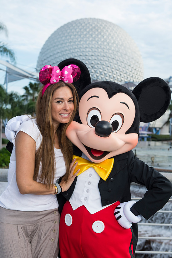 Mexican host Galilea Montijo with Mickey Mouse in front of Epcot's Spaceship Earth