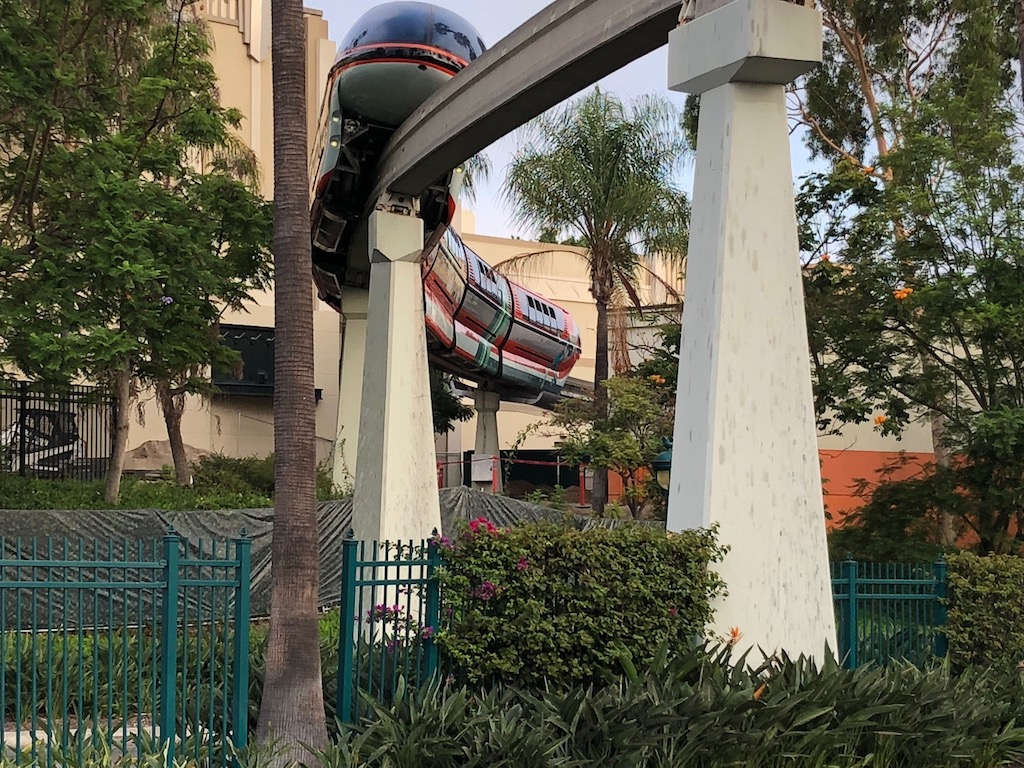 The monorail makes it way through the area between the AMC Theater and the Lego store.