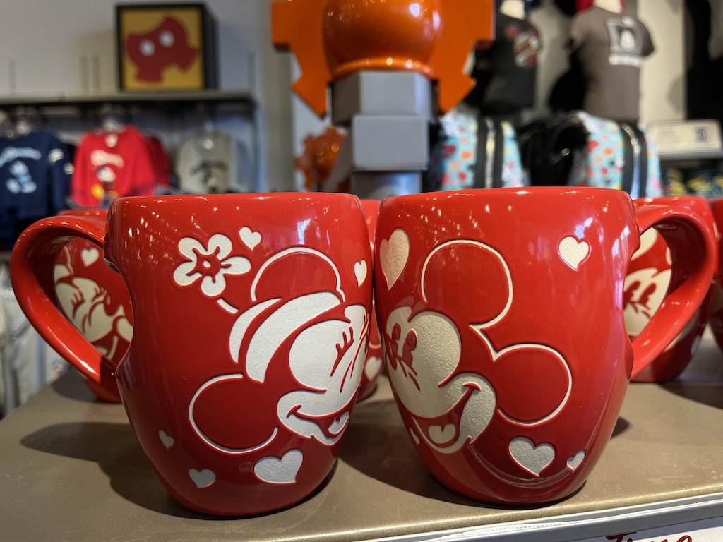 https://www.laughingplace.com/w/wp-content/uploads/2021/02/mickey-and-minnie-mouse-heart-handle-mug-epcot-1.jpeg